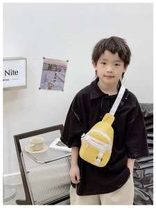 Detail of yellow kids chest bag with letter print and adjustable nylon strap