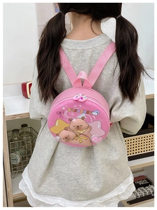 Pink round toddler backpack with cute Capybara cartoon design worn by child at home