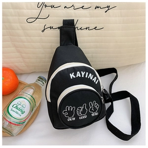 Detailed view of kids' black canvas chest bag with white letter print and palm gestures
