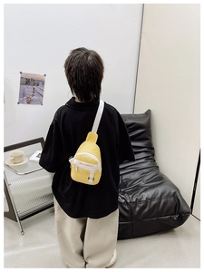 Yellow canvas kids chest bag with KAVINAI lettering and adjustable strap