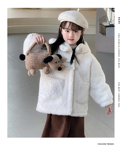 Detail of a handmade crochet puppy shoulder bag for kids paired with a cream coat