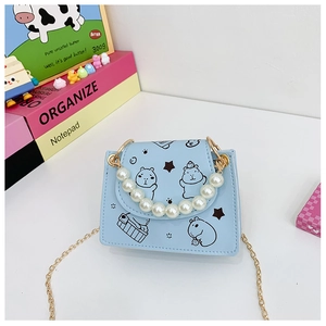 Detail of light blue mini purse with Capybara print, pearl handle and gold chain strap