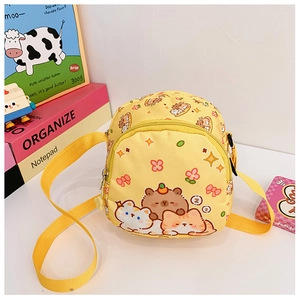 Detail showing yellow cartoon bear crossbody bag with adjustable strap and dual zipper pockets