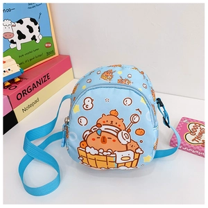 Detailed close-up of cartoon bear print on blue crossbody bag with adjustable strap