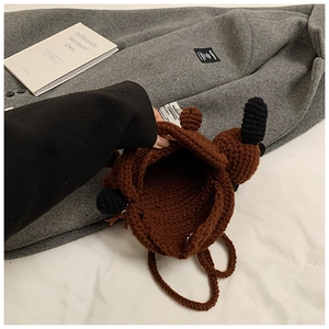 Detail view of the hand-woven puppy bag interior showing the brown crochet texture