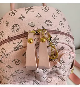 Macro shot of smooth golden zippers on pink leather backpack with geometric patterns