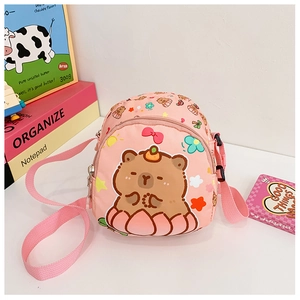 Close-up of pink mini crossbody bag with cartoon capybara print and double zippers