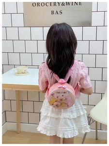 Toddler pink round Capybara backpack shown on a child's back in a cozy nursery