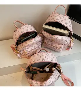 Detailed view of the spacious pink backpack interior with multiple functional pockets