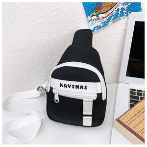 Detail of a black and white canvas chest bag with adjustable strap and KAYINAI logo