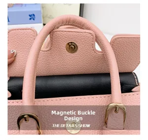 Close-up of pink pebbled leather child bag featuring a gold magnetic snap closure
