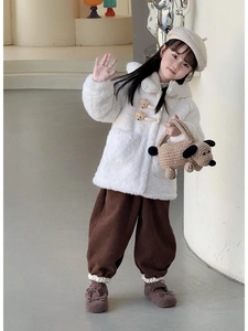 Detail of a handmade crochet puppy bag paired with a winter outfit for a young girl