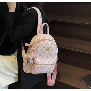Pink mini backpack with NK letter monogram pattern and cute bunny charm pendant accessory