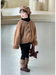 Close-up of a brown knit puppy-shaped shoulder bag paired with a fleece jacket