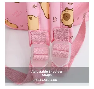 Detail of adjustable pink woven shoulder straps and clear buckles on a kids backpack