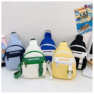 Detailed view of kids colorful canvas chest bags in five vibrant contrast colors