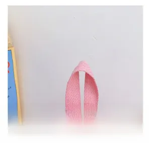 Detailed close-up of a sturdy pink handle on a cute cartoon backpack for kids