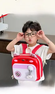 Toddler backpack featuring cat ears and fish charm worn by a young boy in indoor setting