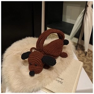 Detailed view of handmade crochet dachshund dog shoulder bag in brown and black yarn