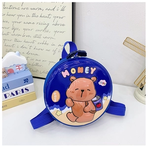 Macro shot of circular hard-shell blue kids backpack with cute cartoon bear pattern