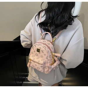 Pink printed mini backpack with NY embroidery and pendant shown in a lifestyle shot