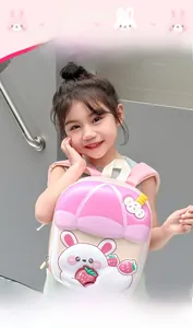 Pink toddler backpack featuring 3D cartoon bunny and strawberry on kid girl model