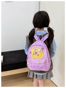Detail of purple children backpack with cute capybara print and lie flat slogan