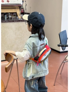 Detailed view of kids colorful patchwork chest bag with multi-zipper compartments