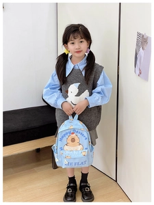 Detail of light blue kids backpack with cute cartoon bear and Happy Dessert print
