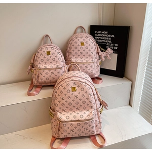 Three-piece set of pink mini backpacks featuring black NK logo and floral prints