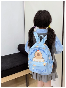 Detailed view of kids blue canvas backpack with cute capybara and donut cartoon print