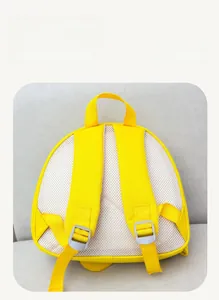 Detail of breathable honeycomb mesh padding and adjustable straps on the yellow kids backpack