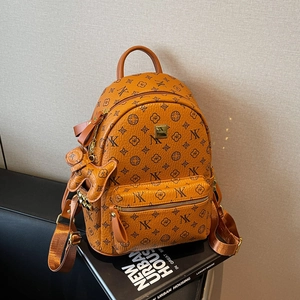 Detail of orange monogram backpack with NK pattern and cute dog pendant charm