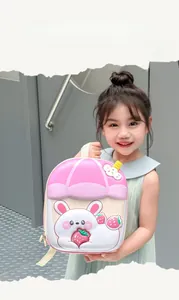 Cute pink rabbit and strawberry 3D shell backpack shown with child on urban background