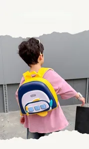 Toddler backpack featuring airplane hard shell design worn by a child from a back view
