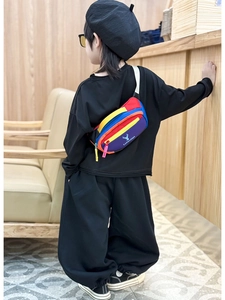 Detailed view of kids colorful patchwork chest bag with deer logo and adjustable strap