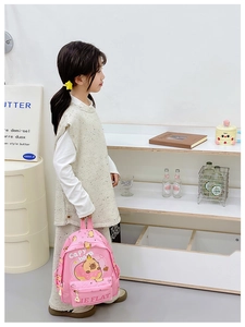 Pink kids backpack featuring cute capybara and donut print with front zipper pocket