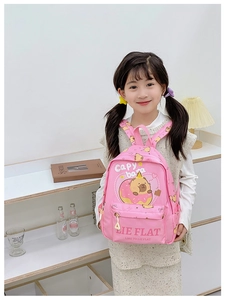 Close-up of pink Capybara backpack featuring a cute cartoon print and front zipper pocket