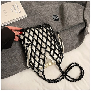 Detailed shot of black beaded woven bag featuring a white satin drawstring inner pouch