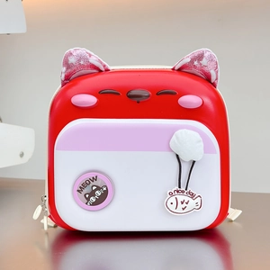 Close-up of lightweight red hard shell kids backpack with cute pink cat ears and meow badge