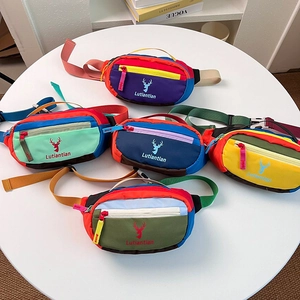 Detail of colorful nylon chest bags with deer logo and adjustable straps for kids
