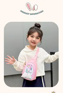 Pink unicorn kids crossbody bag with glitter finish and feather wing detail on toddler model