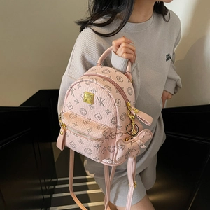 Pink printed leather backpack for women with floral monogram pattern and gold logo plaque