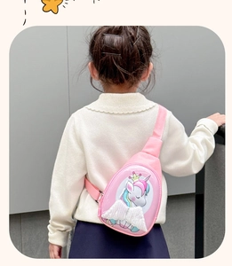 Rear view of a pink cartoon unicorn chest bag with glittery wings on a child model