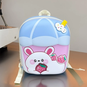 Detail view of the durable hardshell 3D bunny and strawberry relief on the kids backpack