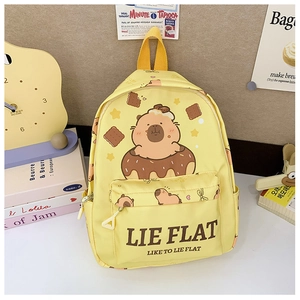 Yellow kids backpack with Capybara print and Lie Flat text in cozy lifestyle setting