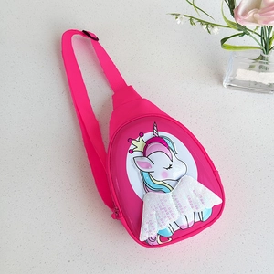 Close-up of pink unicorn kids chest bag with sequin wings on a textured background