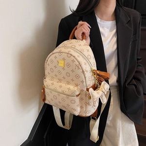 Chic beige and brown monogrammed backpack for women with cute bow pendant and adjustable straps