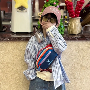 Kids colorful patchwork crossbody bag with reindeer logo and adjustable red strap