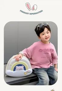 Toddler cute cartoon bear backpack with rainbow details shown on a young boy model